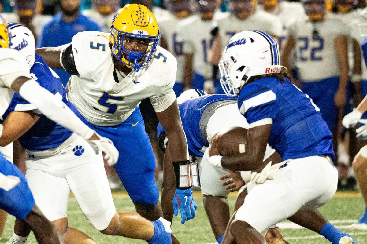 St. Martin defensive end Jayden Curtis (5) sheds a block to make a play on a Stone ballcarrier Friday in the Yellow Jackets’ victory.