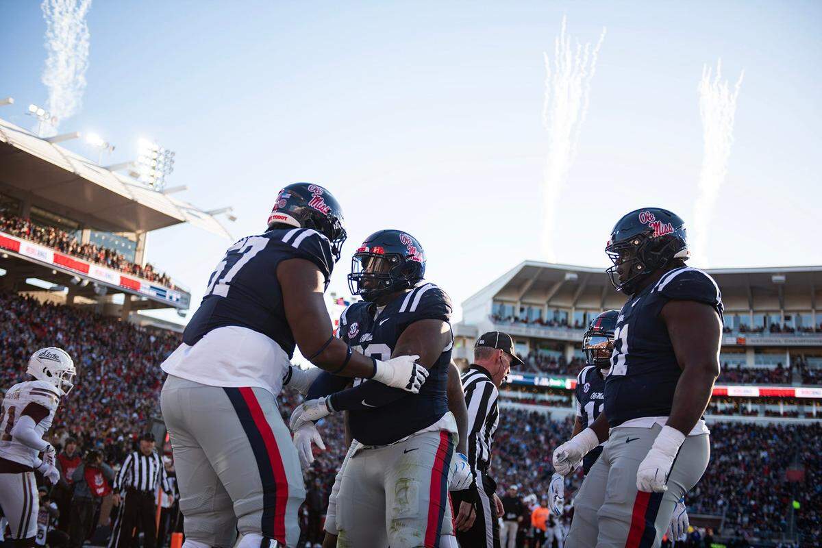 Mississippi's defensive tackle JJ Pegues (38), middle, celebrates after scoring a touchdown during the Egg Bowl game against Mississippi State at Vaught-Hemingway Stadium on Friday, Nov. 29, 2024.
