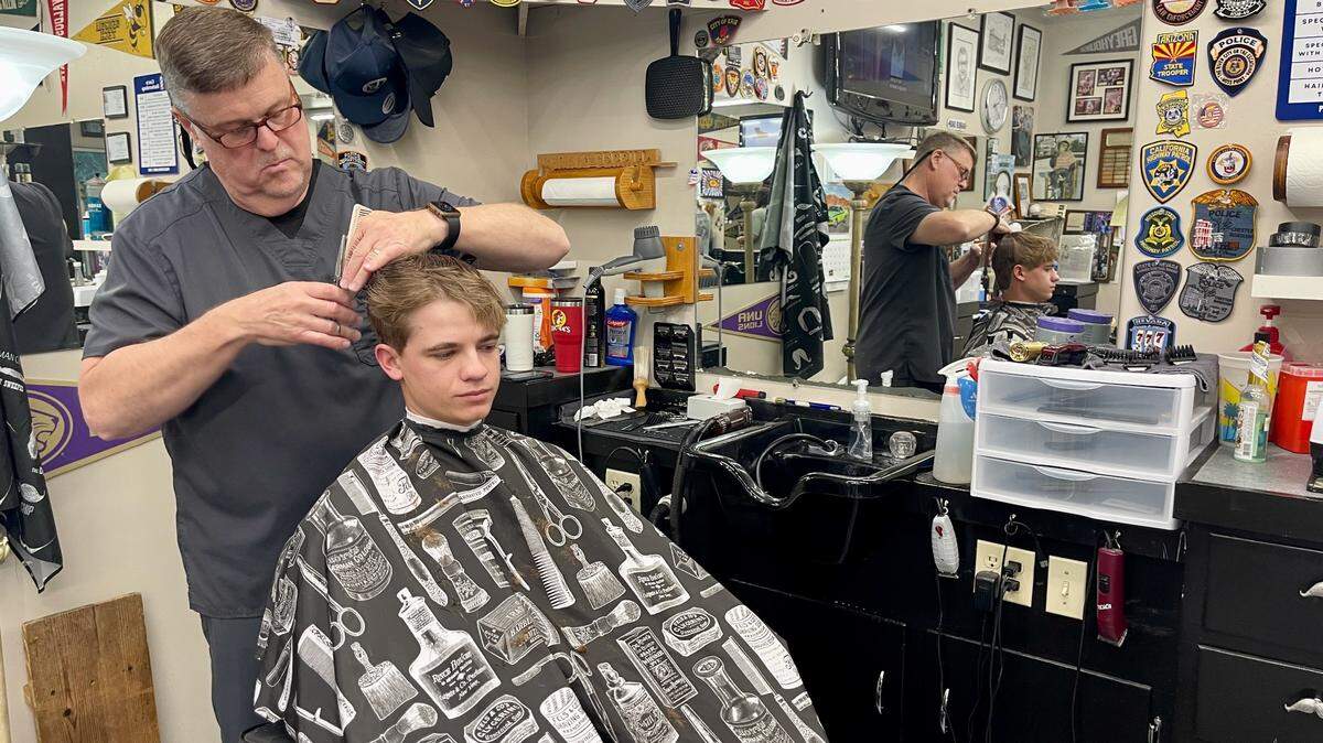 Gerald Ferrill, brother-in-law of Ocean Springs Mayor-Elect Bobby Cox, gives Dennis Parker a trim on Wednesday, April 2, 2025. Ferrill was not surprised by Cox’s resounding victory in the mayor’s race. Ferrill said that he’s heard customers talk for the last couple of years about being unhappy with the city’s direction