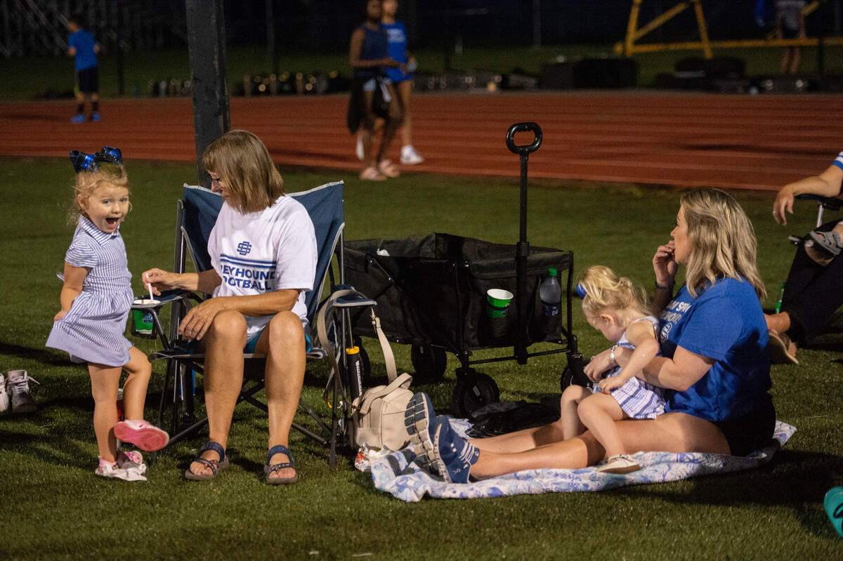 Young Ocean Springs fans their team during a Jamboree game against Gautier at Greyhound Stadium in Ocean Spring on Friday, Aug. 19, 2022.
