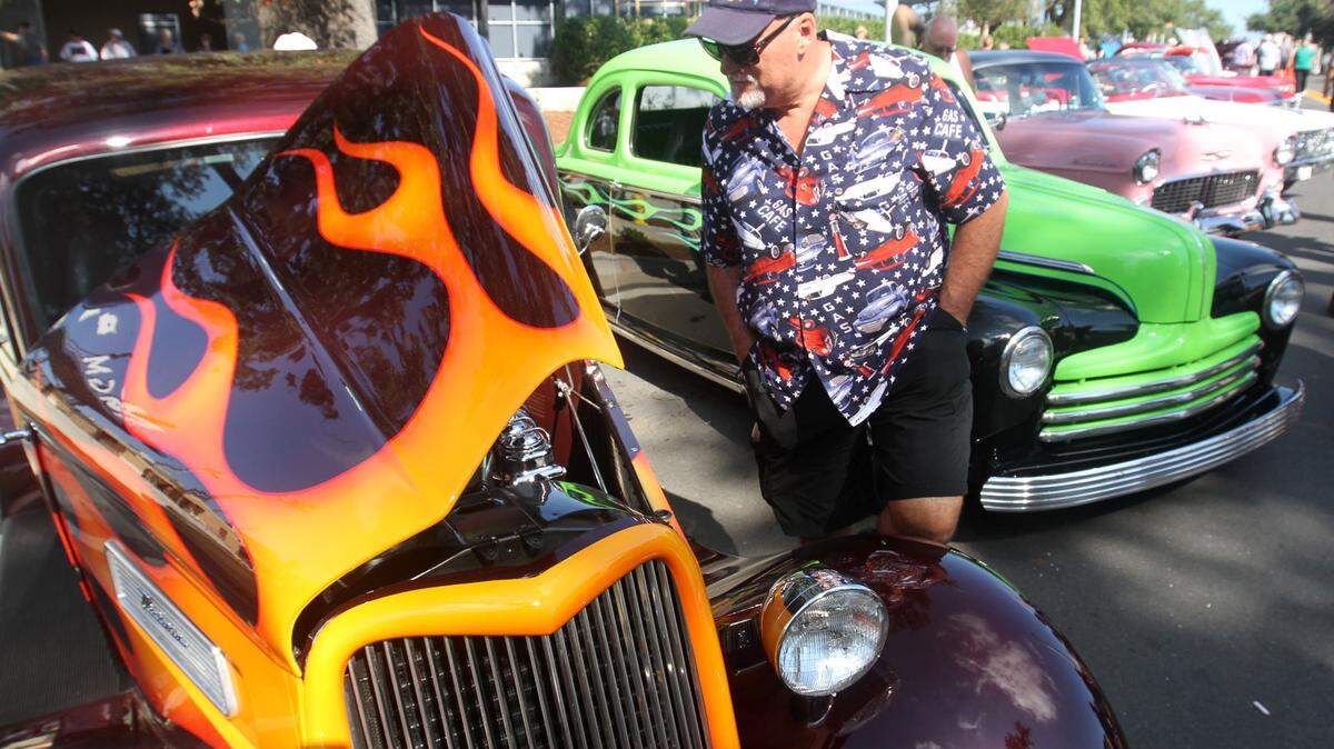JOHN FITZHUGH/SUN HERALDWayne Tedesco of Prairieville, La., looks at a 1933 Ford Victoria at Cruisin' The Coast's Salute to Our Veterans at MGM Park in Biloxi on Tuesday.