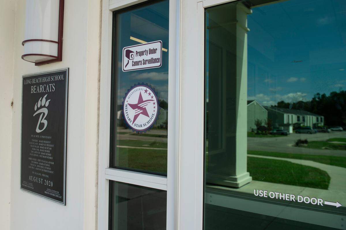 A sign tells visitors that the school is under camera surveillance outside Long Beach High School on Thursday, Sept. 26, 2024. Teachers and students across the country have been dealing with threats and school shootings.