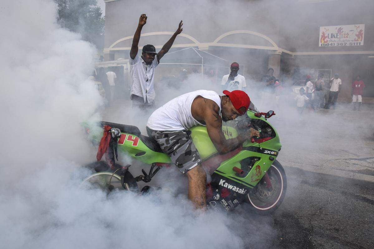 Jerry “J-Hood” Henry does a burnout in honor of a fellow Insane Hunters Motorcycle Club member who died. The tribute was held at the New Orleans intersection where Guy Henderson, best friend of Edna Karr coach Brice Brown, was fatally shot in 2014.