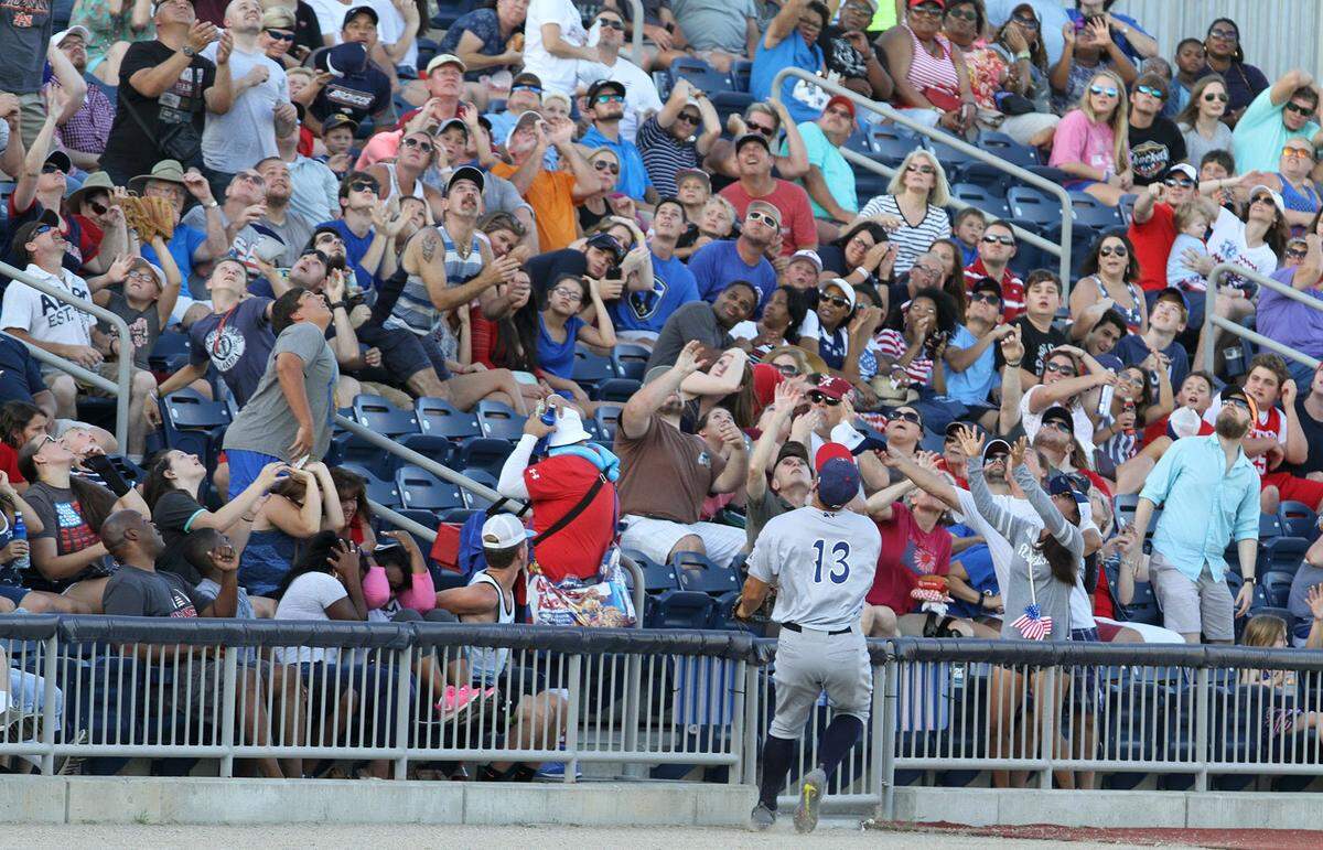 Fans reach for a foul ball during a Biloxi Shuckers game against Pensacola game at MGM Park in Biloxi. The team's home opener is April 12 against the Mississippi Braves.