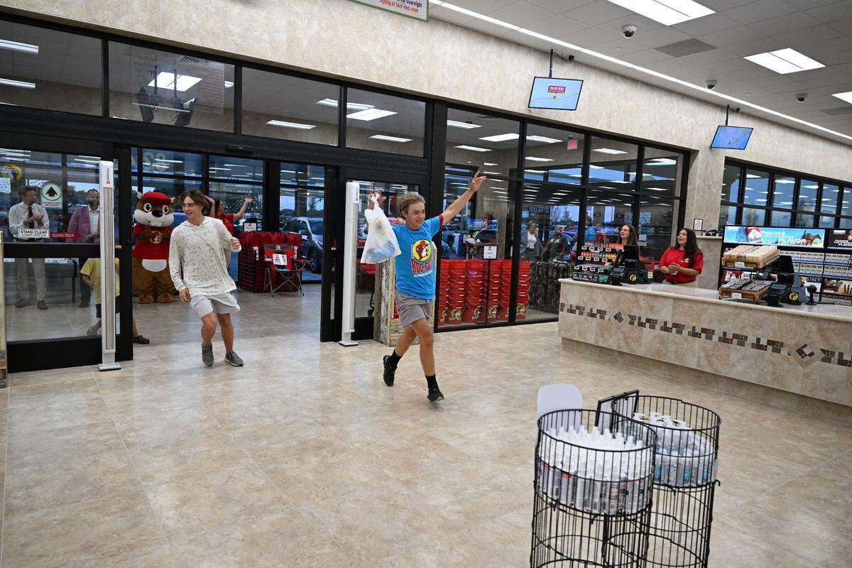 The first fans race into Buc-ee’s at the 6 a.m. opening of the Harrison County location.