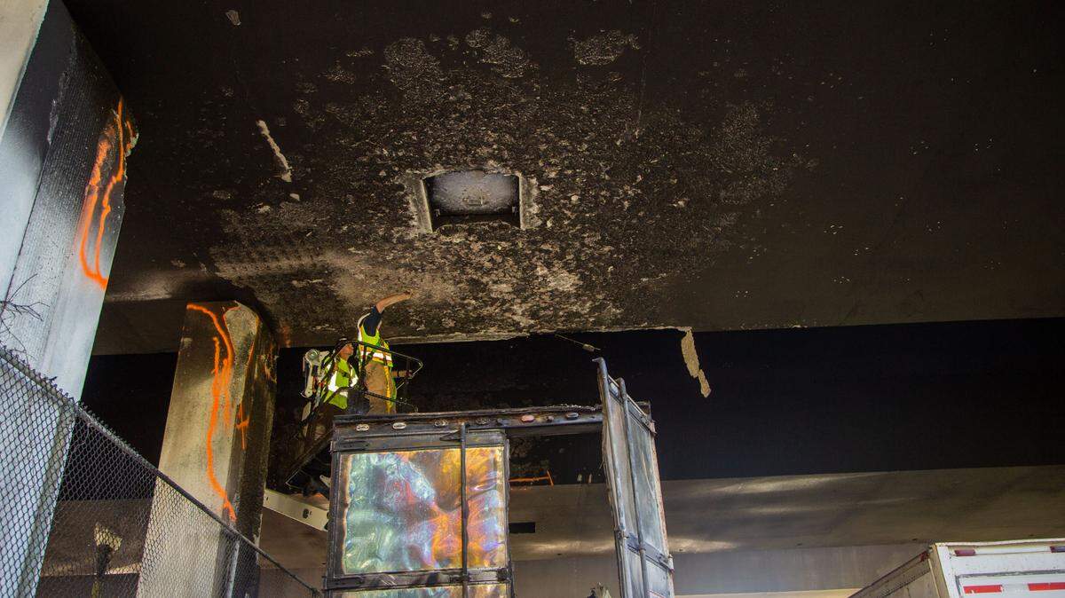 Inspectors from MDOT inspect the underside of the I-110 bridge following a fire that damaged the bridge. The bridge is currently closed to southbound traffic.