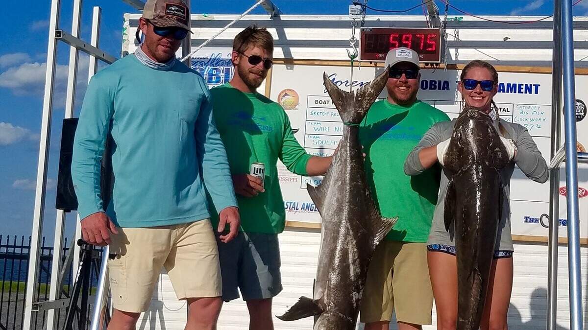 Jeff Harris, far left, and Aubree Harris, far right, and team Strictly Business hold up their first place fish in Gorenflo’s 32nd Annual Cobia Tournament on Sunday, May 6, 2018, in Biloxi. The event returns to Biloxi this weekend.