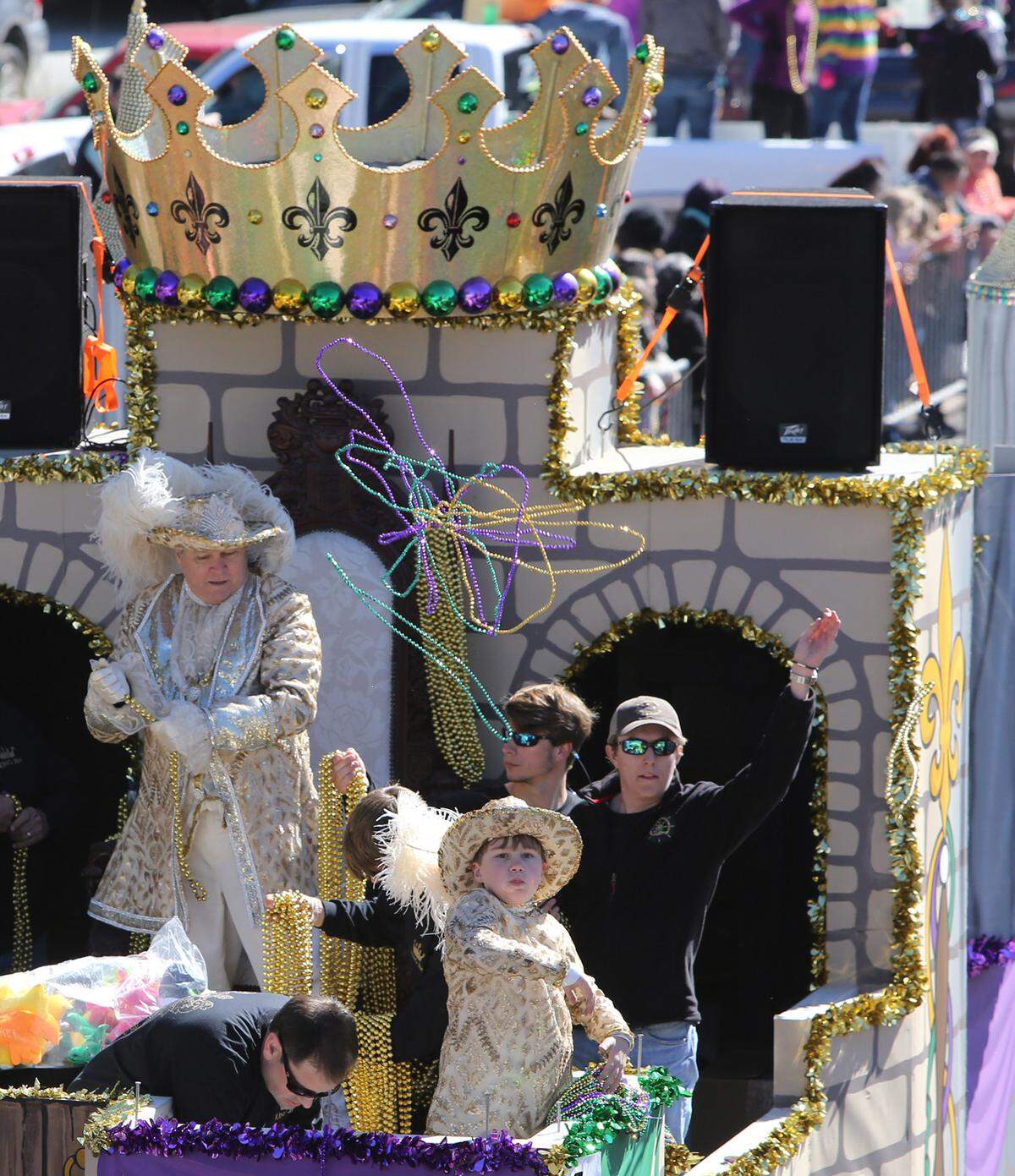 JOHN FITZHUGH/SUN HERALDKing d'Iberville Jim Hardaman tosses throws during the Gulf Coast Carnival Association Mardi Gras Parade in Biloxi on Tuesday Feb. 9, 2016.