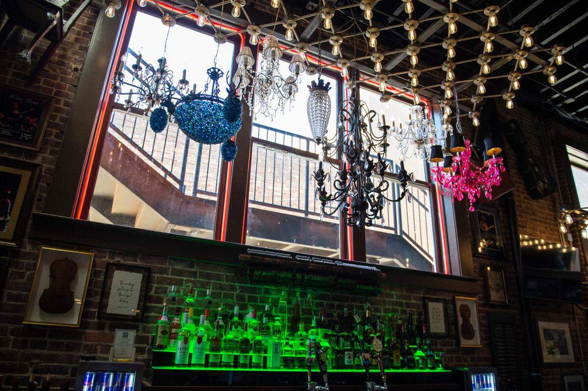Chandeliers hang over the main bar at Ground Zero Blues Club in Biloxi on Thursday, Feb. 10, 2022. The venue features two bars, a dance floor, and a dining room.