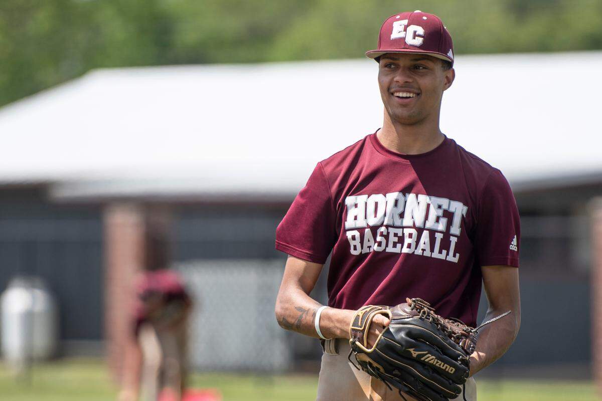 East Central pitcher Anthony Tanner passes with a teammate during practice at East Central High School in Hurley on Tuesday, April 30, 2024.