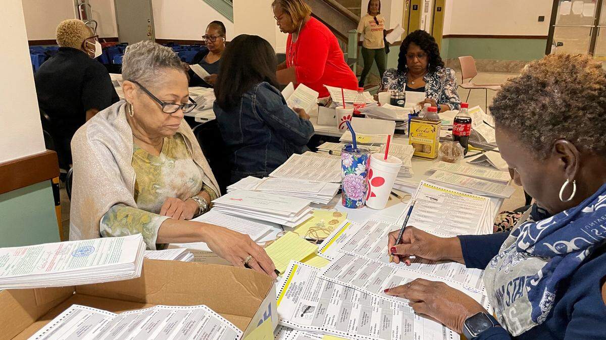 An election resolution board counts absentee ballots Wednesday, Nov. 8, 2023, at the Hinds County Courthouse in Jackson, Miss.