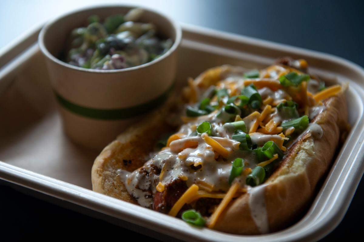 The campfire dawg, which is a hotdog topped with chili, cheddar cheese, green onions and a garlic aioli, at The Garage at Cash Alley in Ocean Springs on Friday, Dec. 13, 2024.
