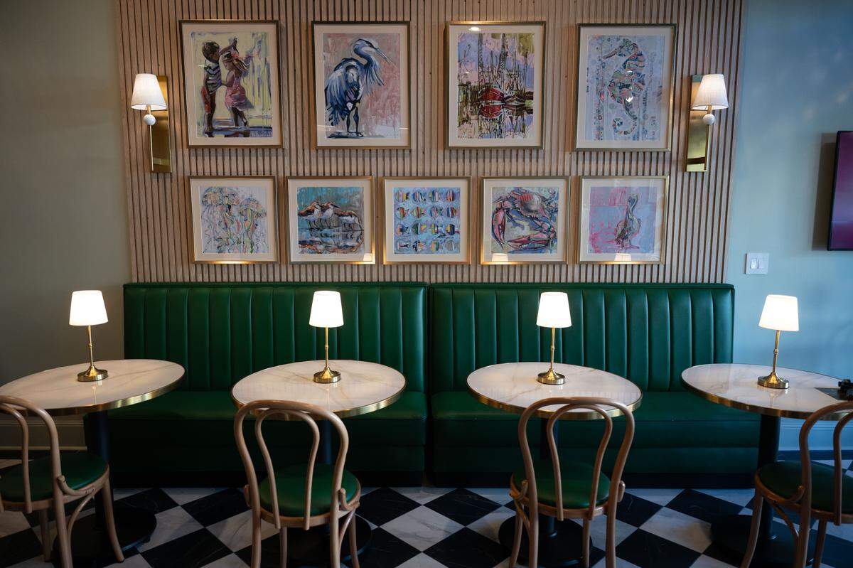 Interior seating and a series of paintings are seen during a soft opening for Neighbors Tap & Table on Thursday.