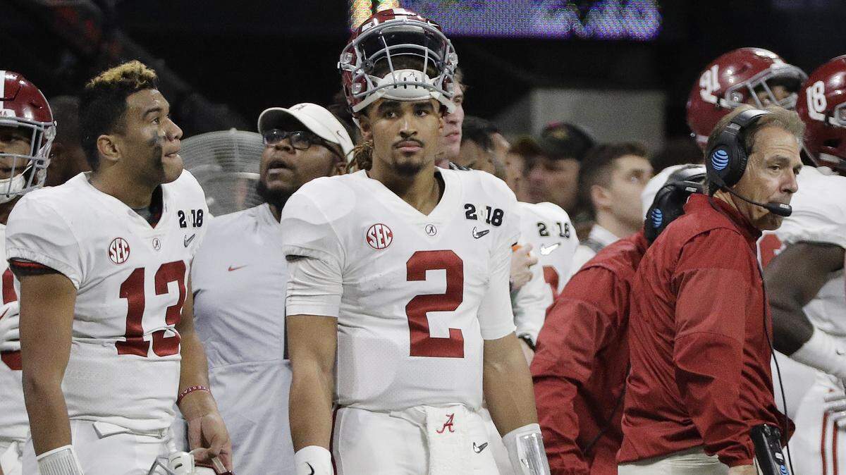 Alabama’s Jalen Hurts (2) is seen on the bench with Tua Tagovailoa (13) head coach Nick Saban during the second half of the NCAA title  against Georgia on Jan. 8, 2018.
