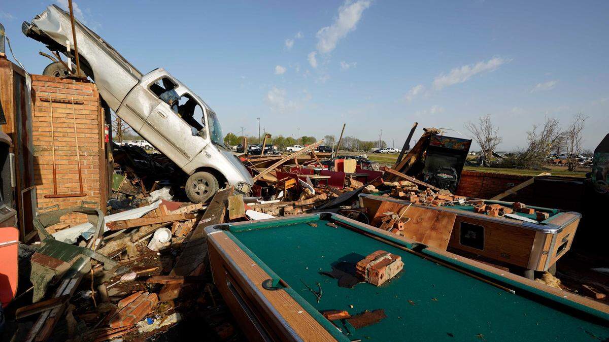 A pickup truck rests on top of a restaurant cooler at Chuck’s Dairy Cafe in Rolling Fork, Miss., Saturday, March 25, 2023. Emergency officials in Mississippi say several people have been killed by tornadoes that tore through the state on Friday night, destroying buildings and knocking out power as severe weather produced hail the size of golf balls moved through several southern states. (AP Photo/Rogelio V. Solis)