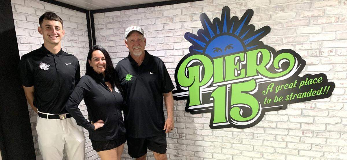 Tucker Thomas, Kim Ivy-Talley and Keith Talley prepare for opening day at the new Pier 15 river bar with entertainment and food on the Biloxi River.