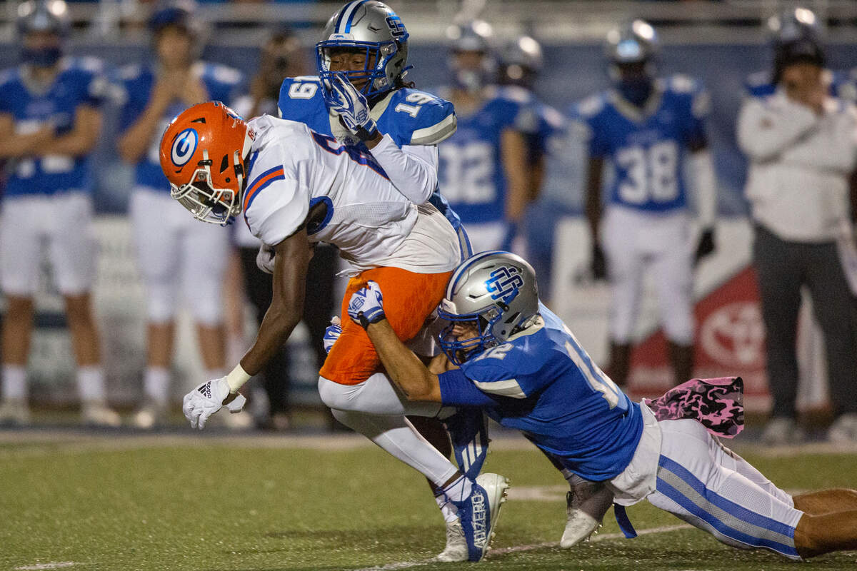Ocean Springs’ Will Gray and Khris Bonds tackle Gulfport during a game at Greyhound Stadium in Ocean Springs on Friday, Oct. 28, 2022.