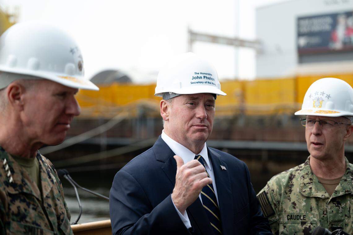 Secretary of the Navy John Phelan, middle, answers questions alongside Admiral Daryl Caudle, right, and Marine Corps General Eric Smith, left, during a press conference at Ingalls Shipbuilding on Wednesday, Jan. 7, 2026.