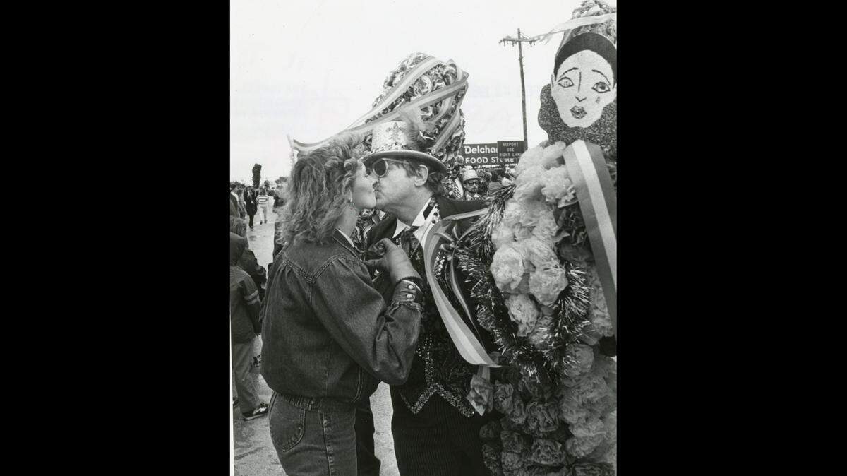 A member of the Ole Biloxi Marching Club gives a Mardi Gras kiss at the Nereids parade in 1987.