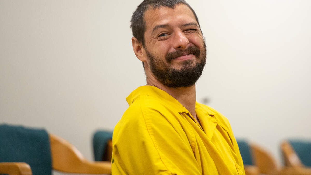 Aaron Blake Haylock, accused of capital murder in the death of his stepfather, Douglas Arguelles, 60, winks at the camera before an initial appearance before Judge Mark Watts in Jackson County Court in Pascagoula on Tuesday, Sept. 5, 2023.