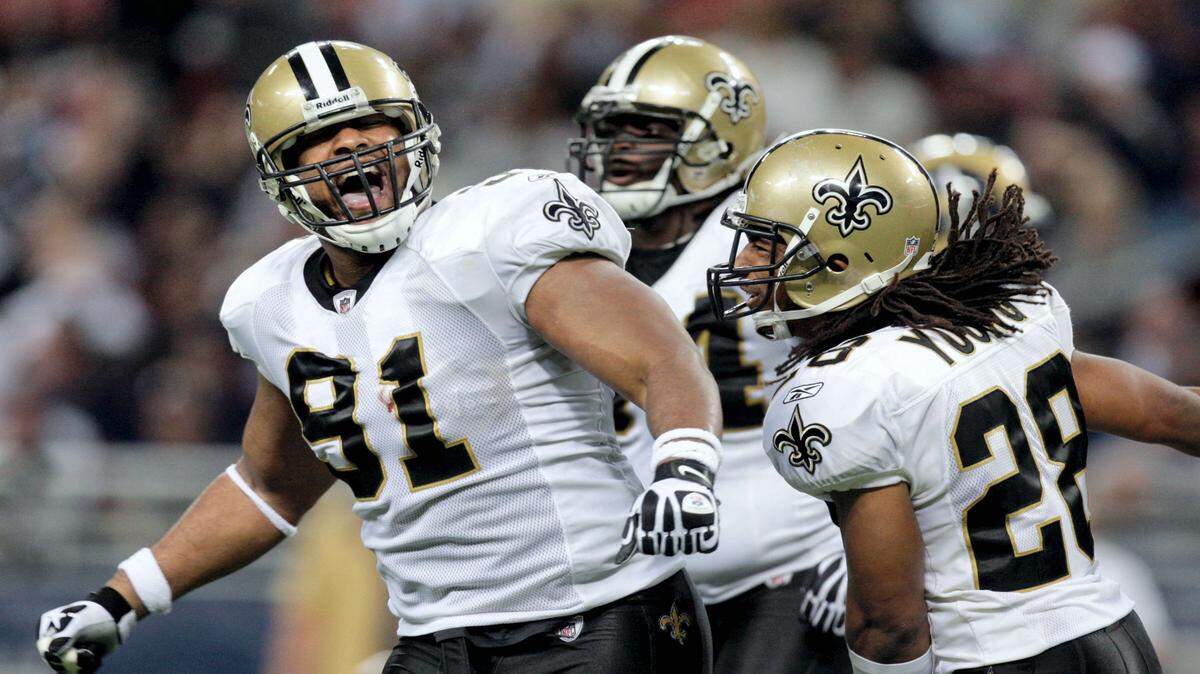 JEFF ROBERSON/ASSOCIATED PRESS 
 New Orleans Saints defensive end Will Smith, left, celebrates with teammates Usama Young, right, and D'Juan Woods, rear, after St. Louis Rams running back Steven Jackson was stopped on fourth down during the fourth quarter of an NFL football game Nov. 15, 2009, in St. Louis. Smith was fatally shot in New Orleans late Saturday night.