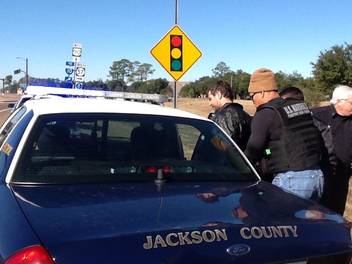 US marshals place Michael Floyd Wilson, aka ‘Pretty Boy Floyd,’ in a patrol car after capturing him in Ocean Springs in 2014. He has escaped prison and is believed to be on the Mississippi Coast.