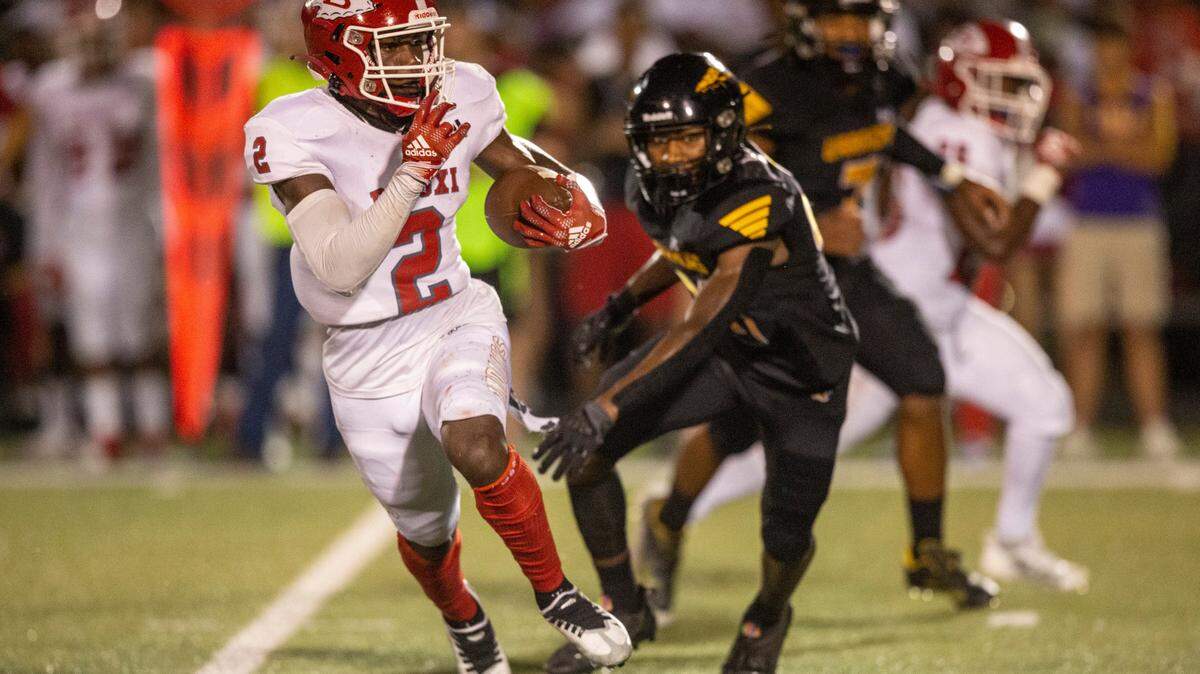 Biloxi’s Damaryion Fillmore evades tackle from D’Iberville during a game at Warriors Stadium in D’Iberville on Friday, Sept. 23, 2022.