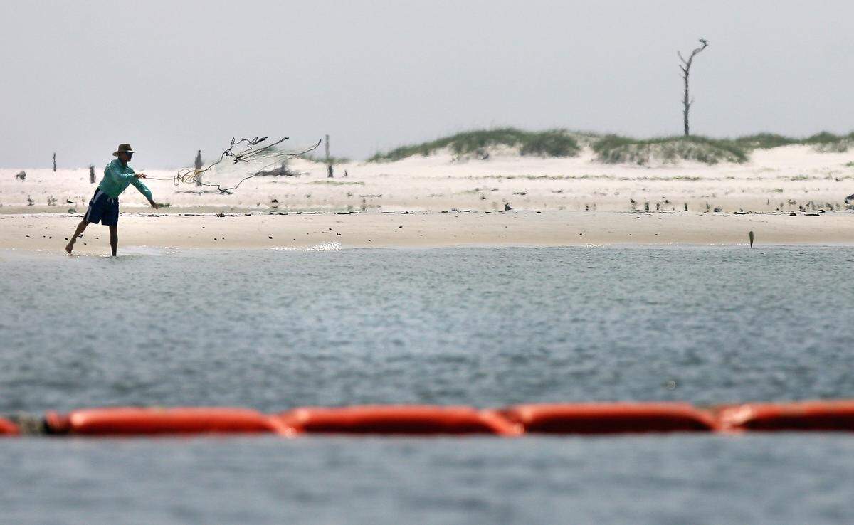 A man throws his cast net out while fishing on the northern shore of Horn Island in this 2010 file photo. A privately-owned section of the island is for sale and the Gulf Islands National Park Service is considering what it would take to purchase the property.