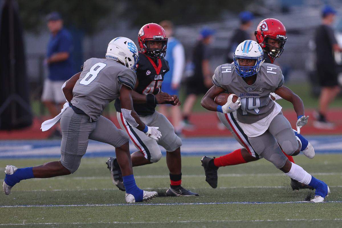 Wide receiver John Paul Coulter (14) carries during the Ocean Springs vs Clinton football game.