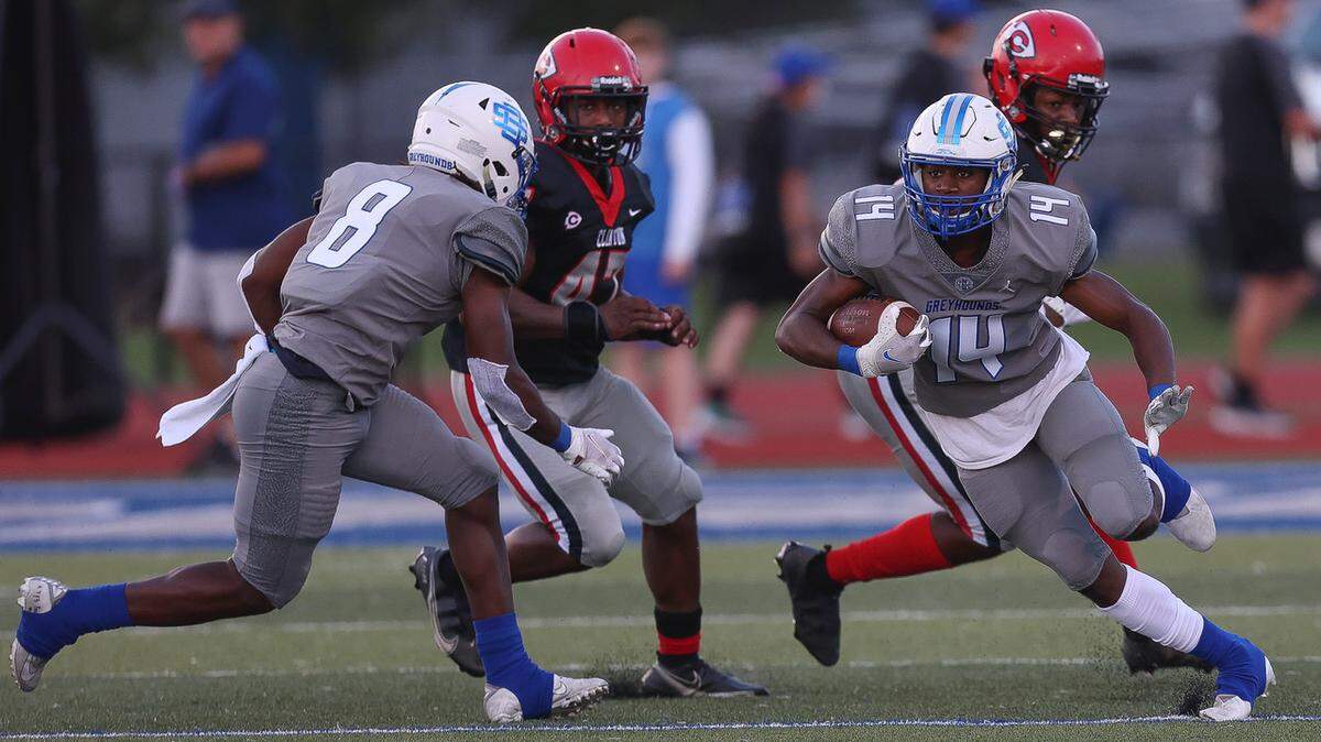 Ocean Springs Greyhounds wide receiver John Paul Coulter (14) carries during the Ocean Springs vs Clinton football game at Hugh Pepper Field, Ocean Springs, MS, Thursday, August 25, 2021.
