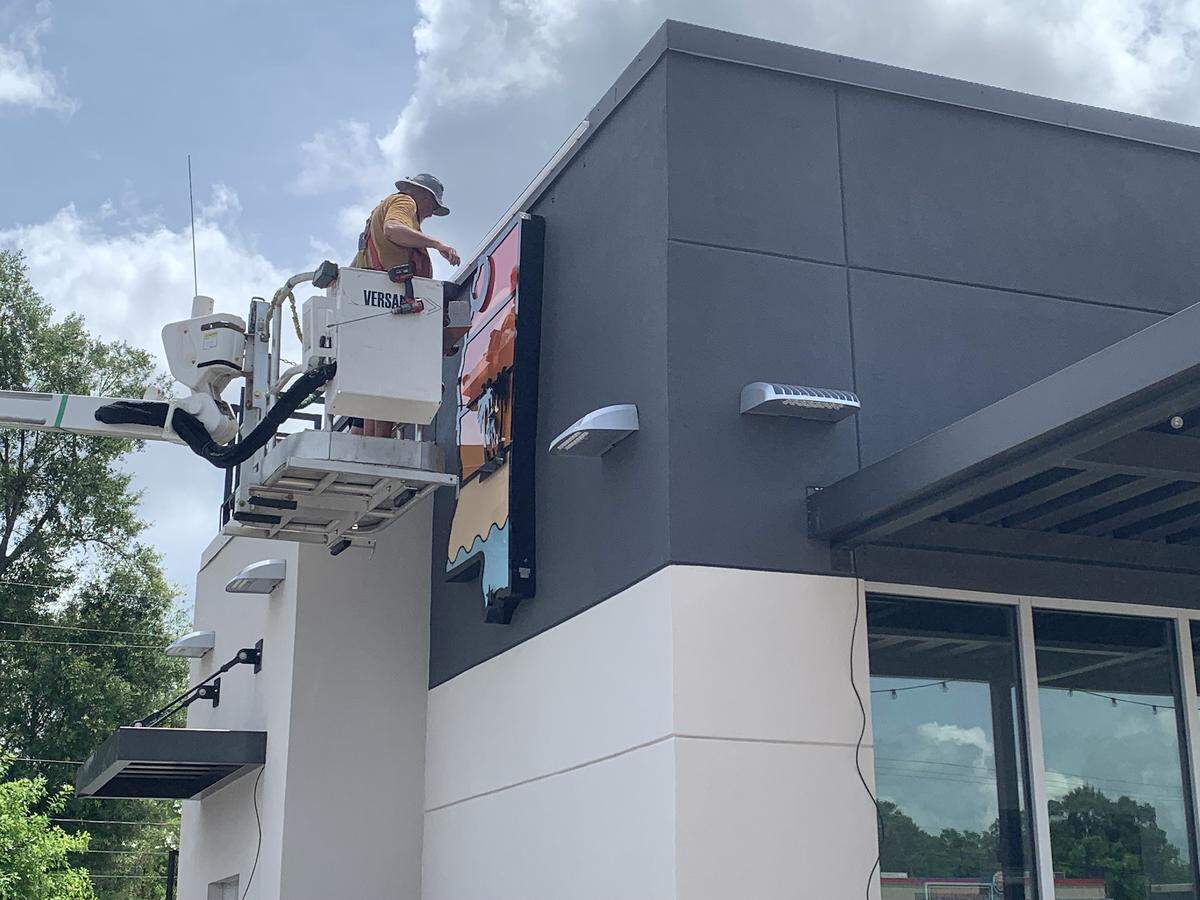 A sign in the shape of Mississippi is installed on the side of the Cookout restaurant, coming soon in Gulfport. This is the franchise’s first location on the Coast.
