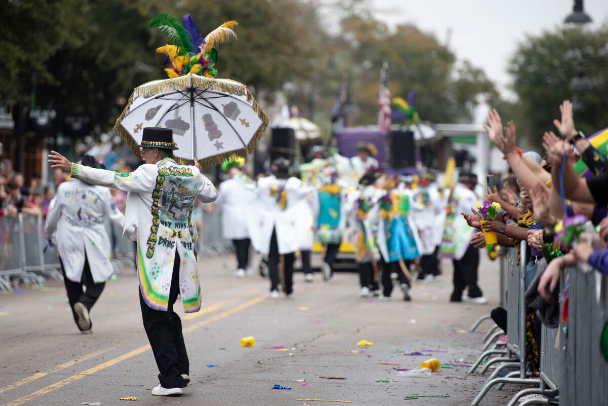 A member of a marching club dances during The Ocean Springs Elks Carnival Parade in downtown Ocean Springs on Saturday, Jan. 27, 2024.