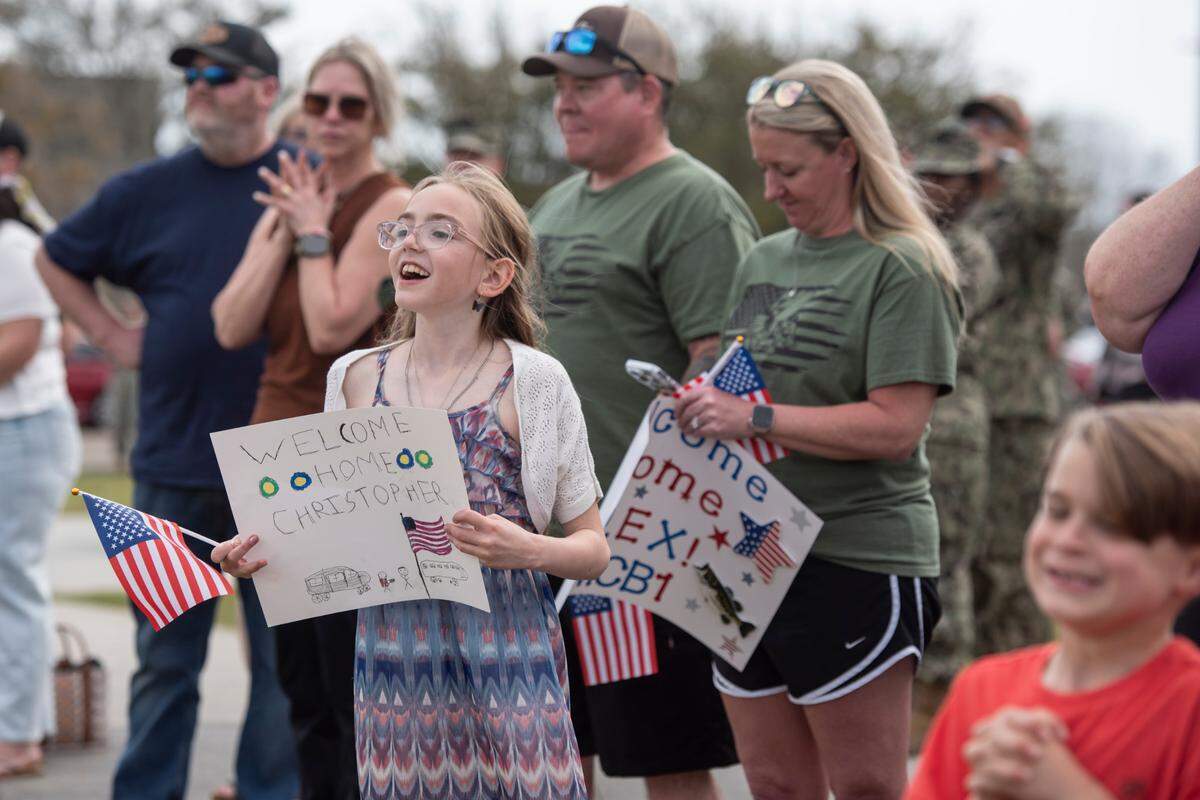 Families await the arrival of members of Naval Mobile Construction Battalion 1 as they return home from deployment on Thursday, March 13, 2025, to Naval Construction Battalion Center Gulfport.