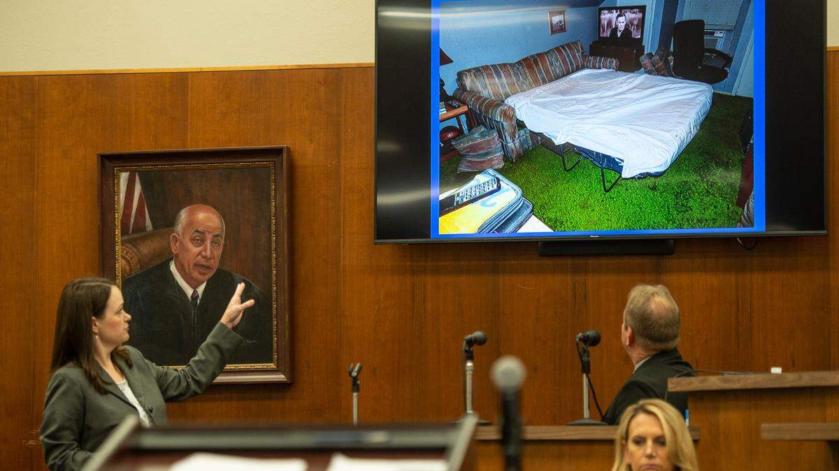 Assistant District Attorney Alison Baker shows Biloxi Police Investigator Steven Kelly a photo of a pullout couch at Cliff Kirkland’s home, where several of the molestation accusations allegedly took place, while Kelly is on the witness stand during the trial of Cliff Kirkland in Harrison County Circuit Court in Biloxi on Monday, May 16, 2022.
