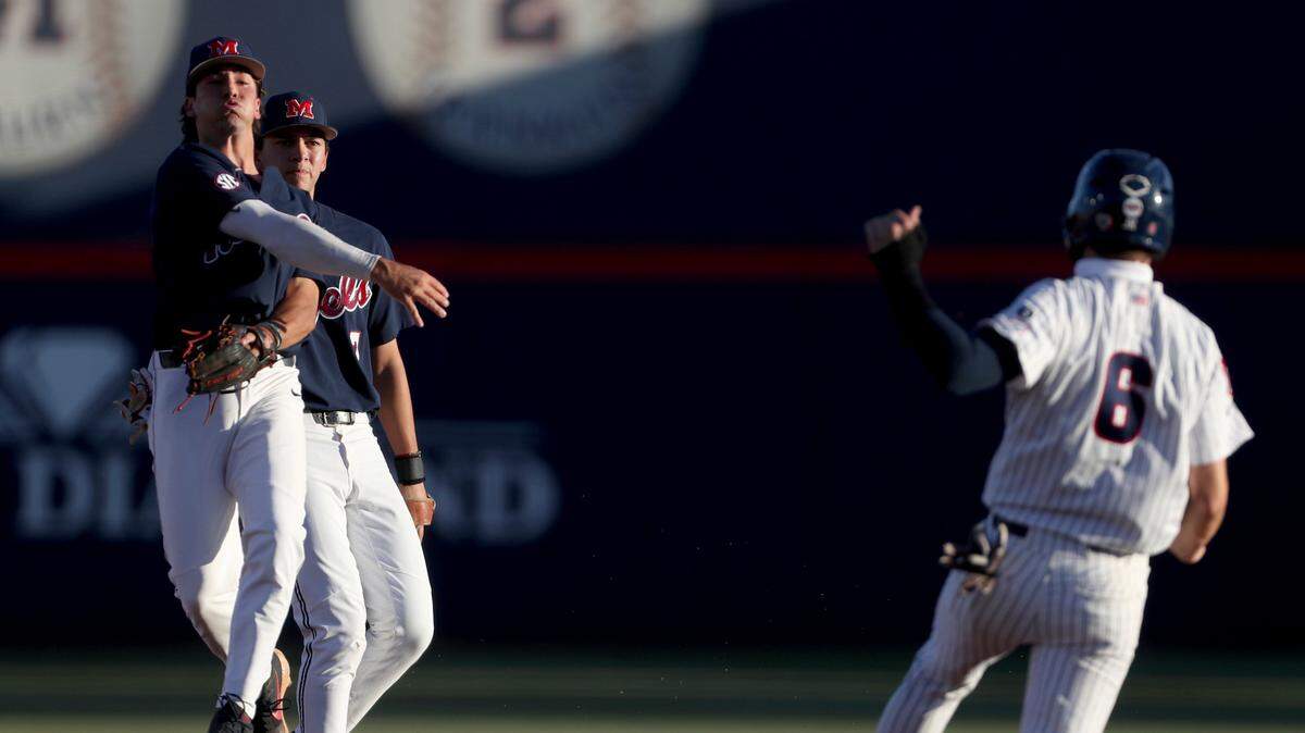 Mississippi second baseman Peyton Chatagnier throws after forcing out Arizona’s Daniel Susac (6) to complete a double play in an NCAA college baseball tournament super regional game Friday, June 11, 2021, in Tucson, Ariz. (Kelly Presnell/Arizona Daily Star via AP)