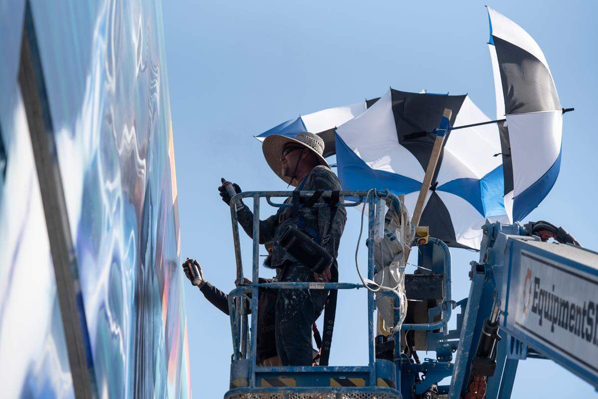 Artist Douglas Hoekzema, also known as Hoxxoh, works on a mural he is painting on the parking garage at the new OS 1515 development in downtown Ocean Springs on Tuesday, Oct. 29, 2024.