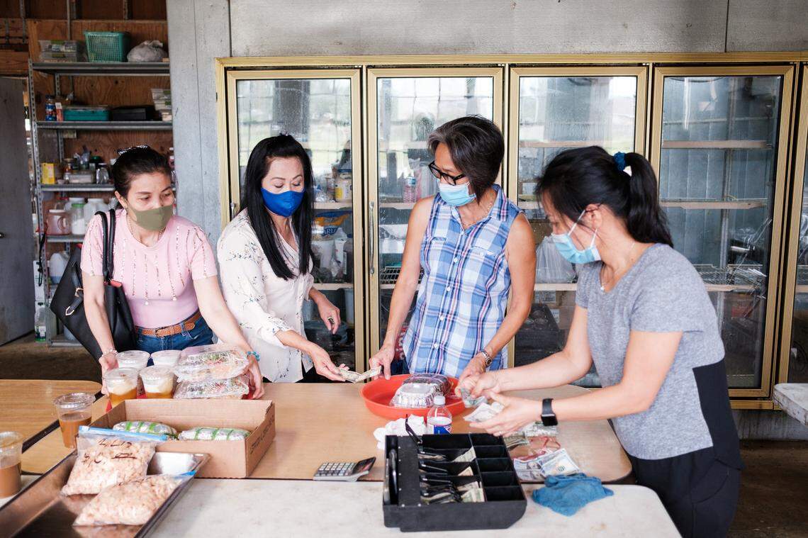 Women of the Vietnamese Martyrs Church in Biloxi prepare food to sell to church members following the morning services on Sunday, Aug. 26.