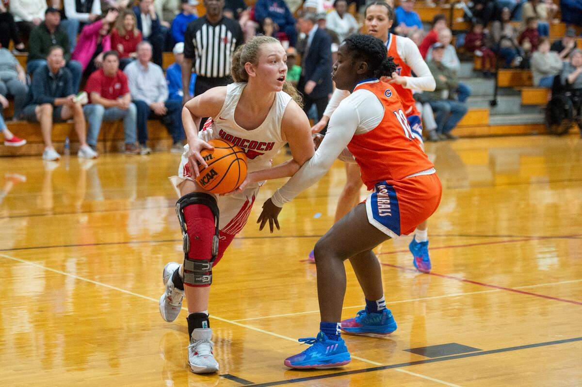 Hancock’s Jenna Garriga dribbles the ball around Gulfport’s defense during a game against Gulfport at Hancock High School in Kiln on Tuesday, Jan. 10, 2023.