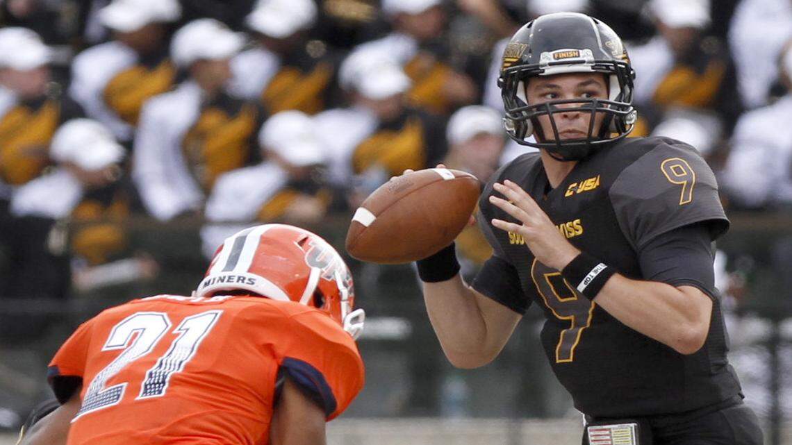 TIM ISBELL/SUN HERALD 
 Southern Miss quarterback Nick Mullens looks for an open receiver as UTEP's Dashone Smith applies pressure, Saturday, Oct. 31, 2015.