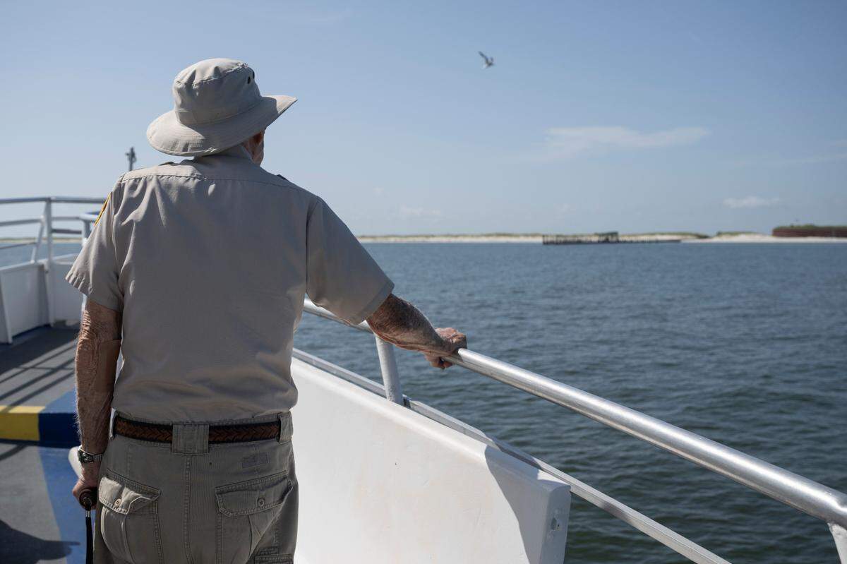 Jack Madison looks over the bow of a boat as it approaches Ship Island on Friday, July 11, 2025. Madison traveled to Ship Island to give one last tour as a volunteer for the Gulf Islands National Seashore and celebrate his 100th birthday.