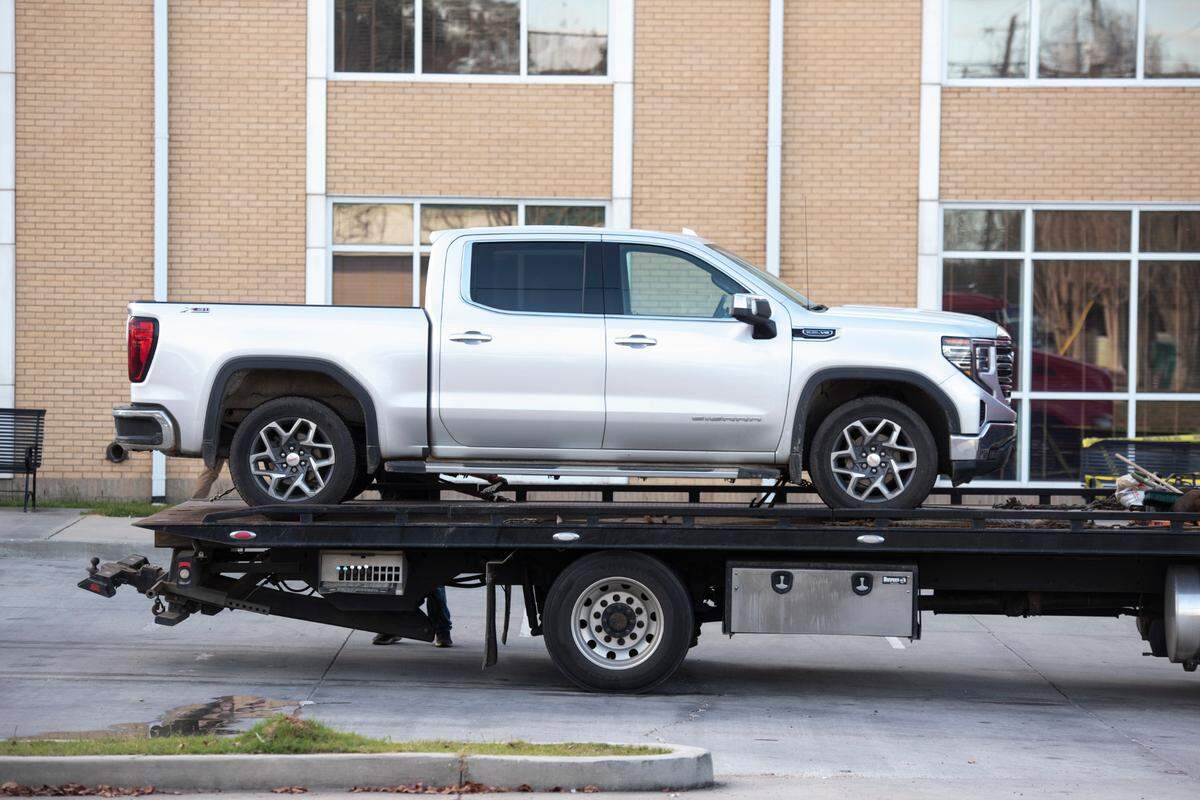 A vehicle is towed from the scene of a shooting outside the Pearl River County Courthouse Annex in Poplarville on Tuesday, Dec. 17, 2024.