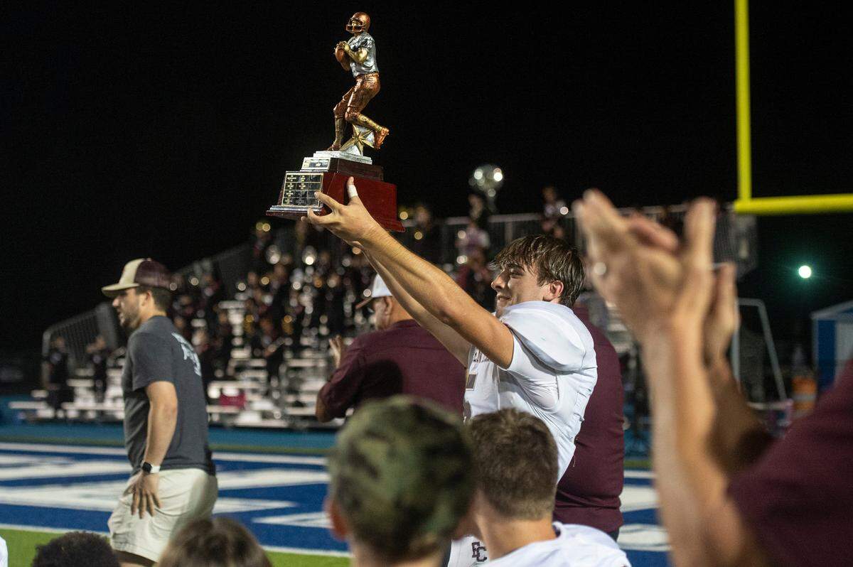 East Central’s Grey Bradley celebrates with the MVP trophy after a game between Vancleave and East Central at Vancleave Football Stadium in Vancleave on Thursday, Nov. 3, 2022.