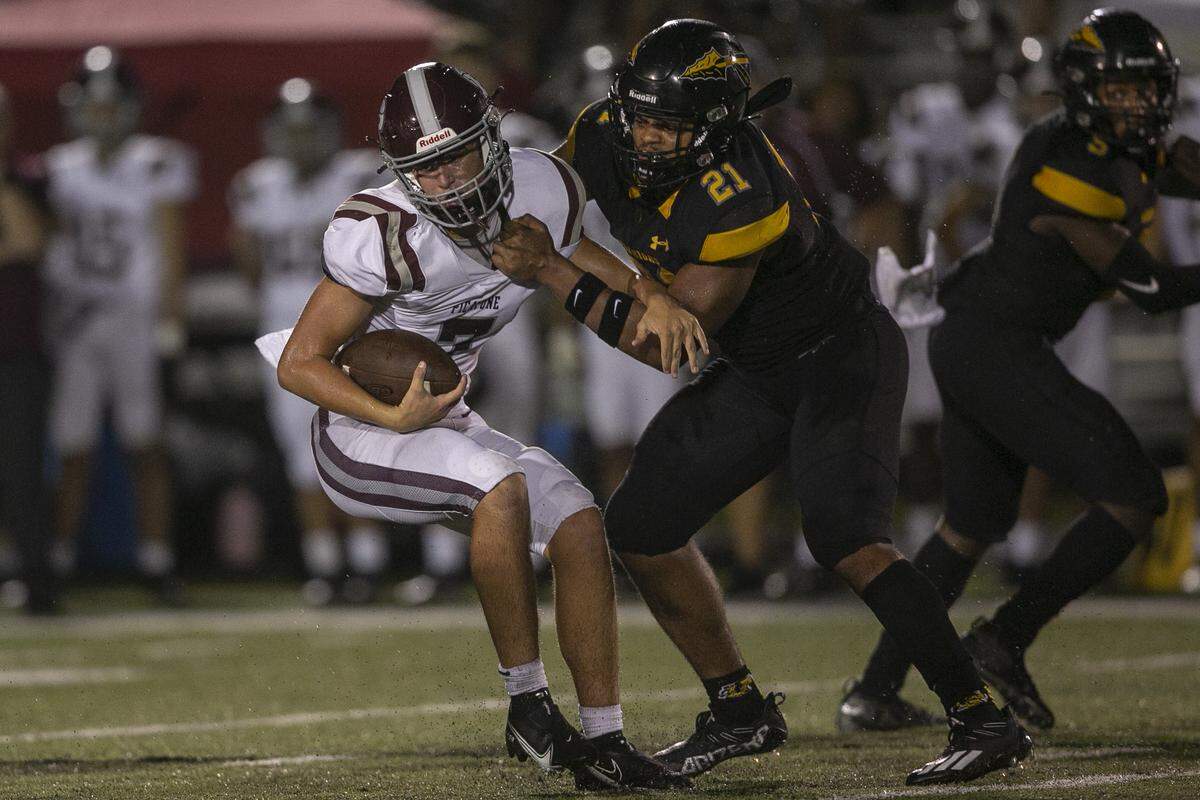 Picayune quarterback Dawson Underwood is tackled by D’Iberville’s Manny Duplessis during the D’Iberville versus Picayune game at D’Iberville Stadium on Friday, Sept. 17, 2021.