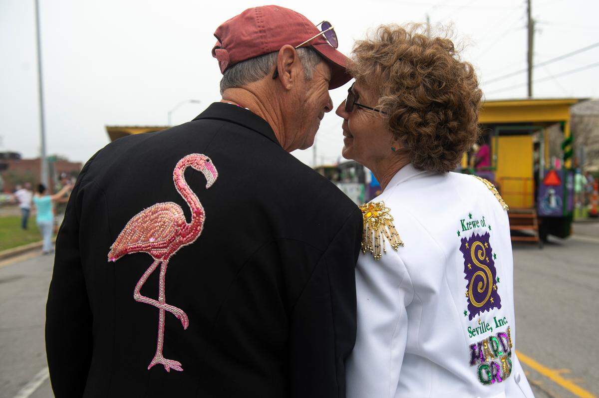 Norm and Edie Pocase, right, of Pensacola wear jackets for the Pensacola krewe Order of the Seville before the Gulf Coast Carnival Association parade in Biloxi on Tuesday, Feb. 21, 2023.