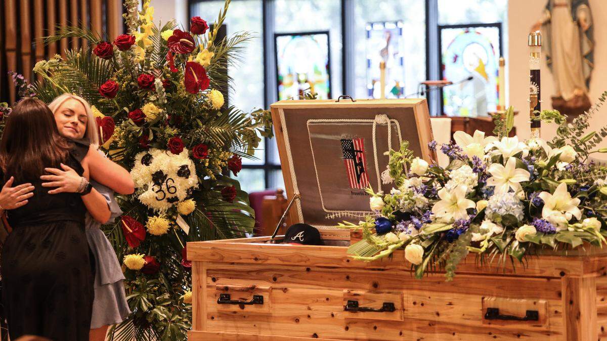 Cassie Lassabe, girlfriend of Cayce Seal, hugs a guest during his funeral service at St. Clare Catholic Church in Waveland on July 1, 2021.