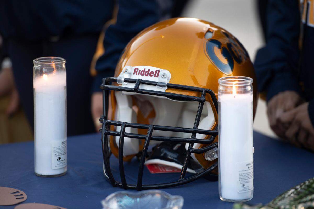 A Gators football helmet sits on a table as mourners enter Vaughn-Wallace stadium at Gautier High School on Thursday, Jan. 16, 2025, for a vigil for Gautier High School student Shermarion Miner. Miner died suddenly after working out in the high school field house.