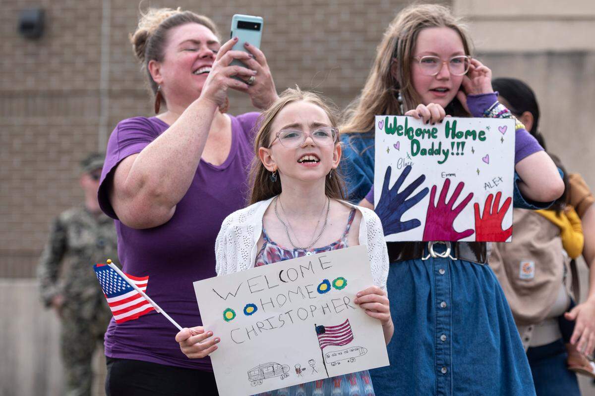 Families await the arrival of members of Naval Mobile Construction Battalion 1 as they return home from deployment on Thursday, March 13, 2025, to Naval Construction Battalion Center Gulfport.