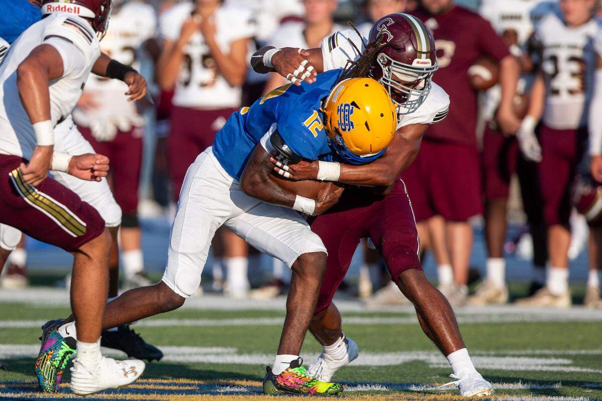 George County linebacker TJ Love tackles St. Martin quarterback Kevin Marshall (#12) during a Jamboree game against St. Martin at St. Martin High School in Ocean Springs on Friday, Aug. 23, 2024.