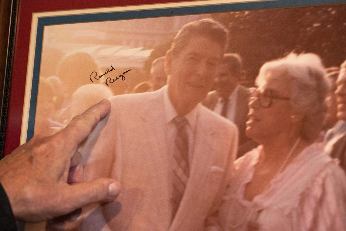 Mary Mahoney’s owner Bobby Mahoney points out the autograph of Ronald Reagan on a photo of his mother and the former president when she was invited to serve food on the White House lawn.