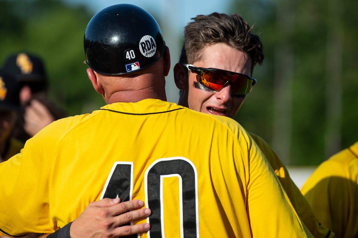 Coach Scott Berry hugs Dustin Dickerson after losing their chance at going to the College World Series during the Super Regionals Final at Pete Taylor Park in Hattiesburg on Sunday, June 12, 2022.